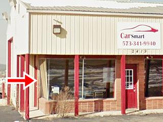 plate glass windows of old gas station office