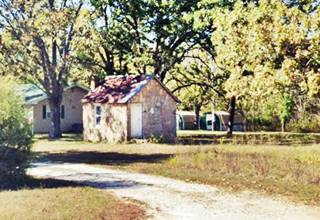 stone cabin surrounded by trees seen from Route 66