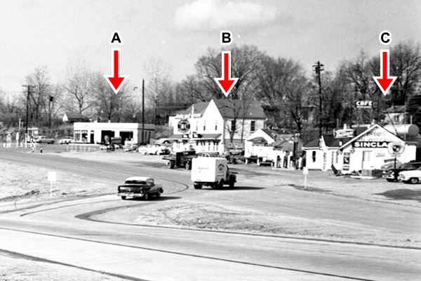 four-lane US66, cars and exit ramp to gas station and buildings along it; black and white photo from 1956
