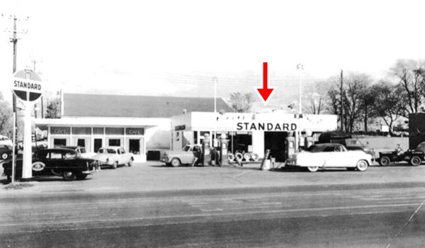 black and white photo 1950s gas station with cars