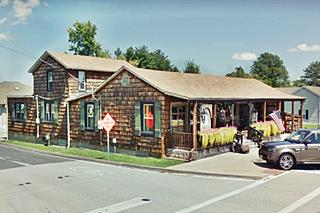 long one story wood building with porch