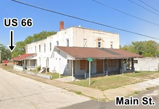 old vacant two story wood frame hotel on a corner