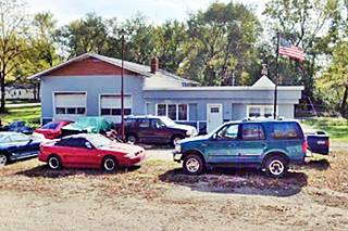 blue gabled roof building former gas station