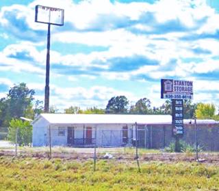 a motel converted to a storage, gable roof, storage units and old neon sign repurposed