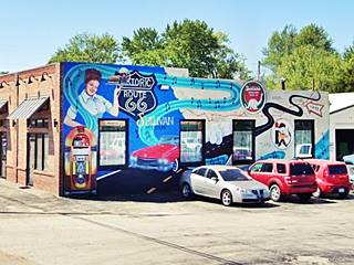 colorful mural with nostalgic Route 66 scenes and a map