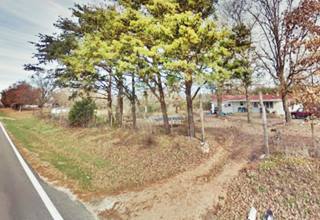 site of That’s it motel, US66 trees by roadway, site of a burned motel