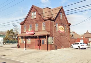 two and a half story cross gable roof brick building