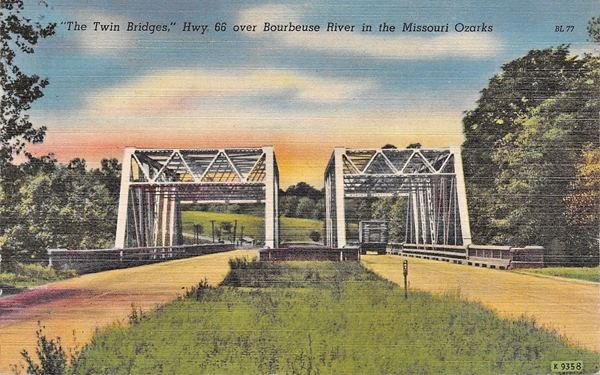 Two steel bridges side by side among trees in a vintage color postcard