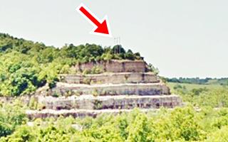 Utility poles on ridge near Route 66 in Arlington power line poles on top of a wooded ridge seen from I-44