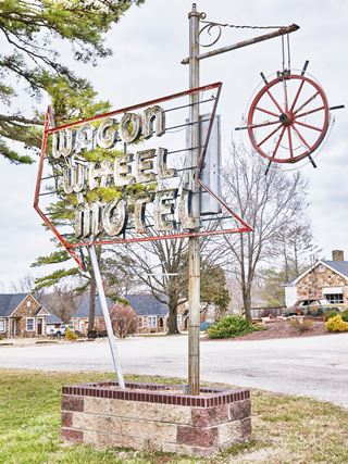Wagon Wheel motel neon sigh by Carol M. Highsmith vintage neon sign with a wheel and the words "Wagon Wheel Motel"