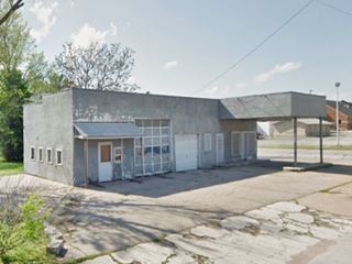 old oblong box with canopy gas station on corner
