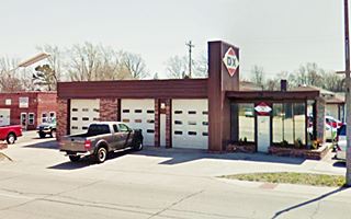 Woods DX now former 2 service bay and glazed office gas sta with central panel on roof