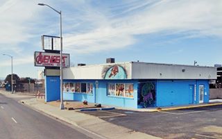 graffiti covered building, flat roof, former neon sign to the left, seen from US 66