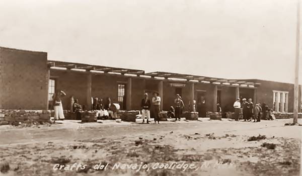 Crafts del Navajo Trading Post, Coolidge NM Route 66 people standing in front of pueblo style, vigas and poles supporting a wide porch black and white 1930s photo