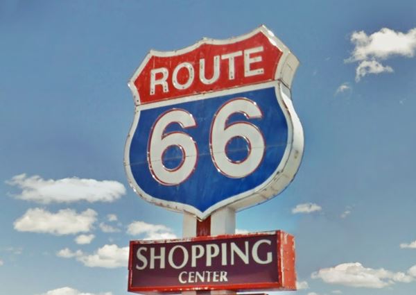 red white and blue US66 shield on a signpost