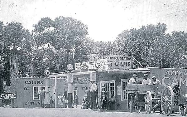 black and white gas station, pumps, cabins, a cart and people