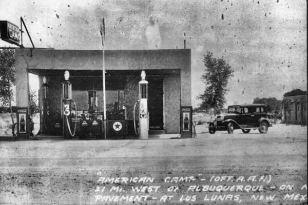 black and white gas station, pumps, cabins, a car