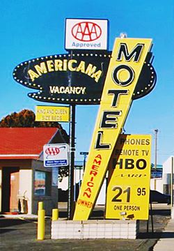 Americana Motel neon sign, US66 Tucumcari classic 1950s neon sign yellow and black bold shapes, Route 66 Tucumcari