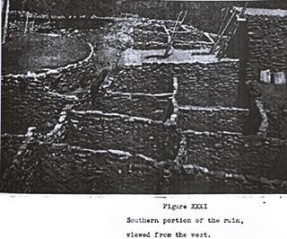 1937 Arrowhead Ruin black and white rock walls, buildings with ladders, a Pueblo ruin