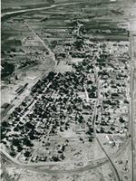 1950s aerial view of Bernalillo 1950s black and white aerial photo town with higway through it, homes, fields
