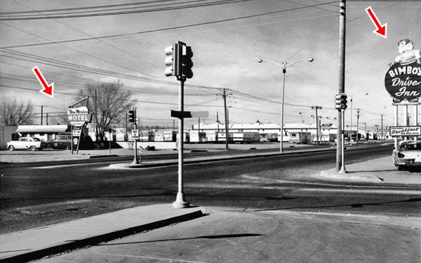 1950s black and white picture intersection, Bimbo’s sign to the right, Route 66 heads away, and New Mexico Motel sign left. Car