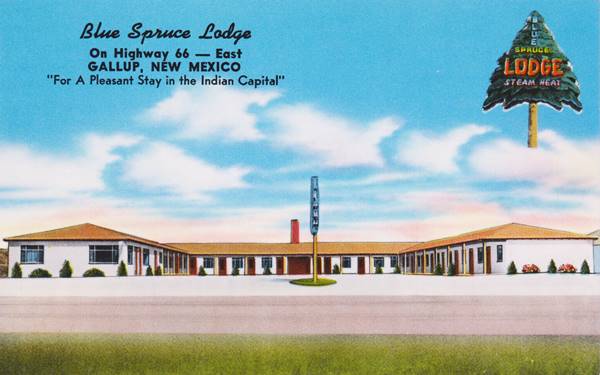 1950s postcard of a U-shaped motel with a pine-tree shaped neon sign gable roofs