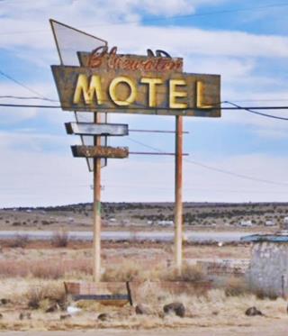 faded rusty 1950s neon sign with yellow letters spelling MOTEL and red script above reads: BLUEWATER