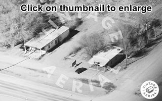black and white view two buildings former cafe (left) and motel (right) and US66 passing in front of it from 1990