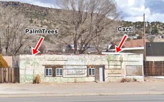 Cactus gardens nowadays Milan NM cacti and palm trees painted on white wall of a single story building. Fading and flaking