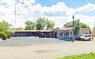 L shaped mall, single floor, parking area and sign reading Cactus Mall