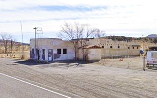 Los Cerritos gas station nowadays US66 Cubero block shaped building, hills beyond US 66 in front