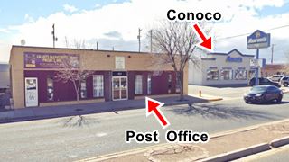 site of former 1930s Grants Post Office and Conoco corner single story building, and across the street a gas station, seen from Route 66