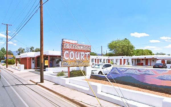 motel and neon sign, single story flat roof