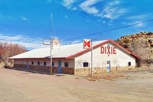 color view, single story bldg. gable roof and neon sign name DIXIE CAFE