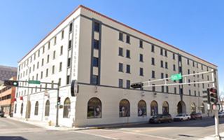 block shaped 5 story building on a corner