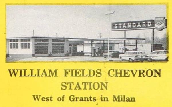 W Field Chevron station 1950s advertisement, Milan NM. 1950s black and yellow printed advertisement of a Chevron gas station depicting its 2 bayst and flat canopy with 1950s cars parked by it