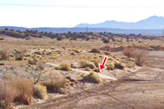 Ford on dry arroyo, Route 66 desert with shrubs, a concrete slab ford at a dry arroyo, Sandia mountains beyond, red arrow marks ford