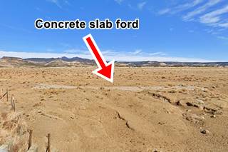 Cubero Route 66 Ford concrete slab ford across dry creek in a desert with hills in the distance