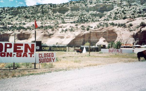 color, cliffs, with caves, wood fence, signs, a trading post