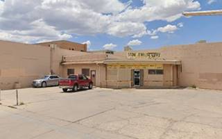 former gas station on a corner, building in the back angle. Angled office