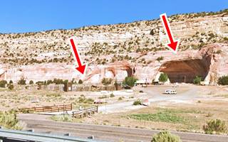 Ft. Yellowhorse 2022 field, and a cave at the base of a cliff, building with wood palisade and highway runs in front