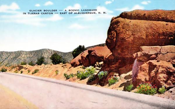 color linnen postcard depicting large rock to the right, by the 2 lane US66 Highway