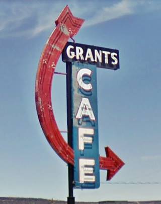 color: neon sign from 1958. Says GRANTS in upper black box, white letters, CAFE in white letters, vertically on blue box. Red arrow curves around downwards