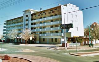 six story block shaped building, a 1960s hotel, Route 66 runs in front of it