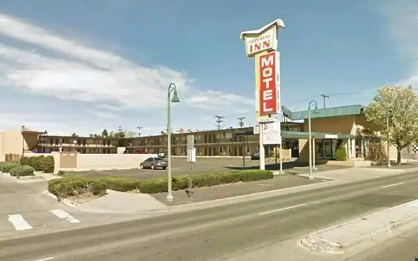 motel, office, 2 floors. Pool, neon sign