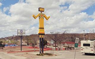 large sized roadside Kachina doll in a park