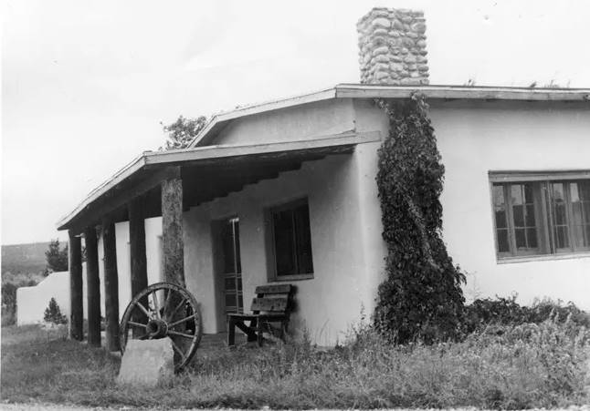1957 view Kozlowski ranch gable roof single story building, stone chimney, verandah, black and white, 1957