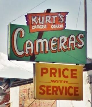 yellow, red and green 1950s shop neon sign: KURTS, CAMERAS, PRICE WITH SERVICE