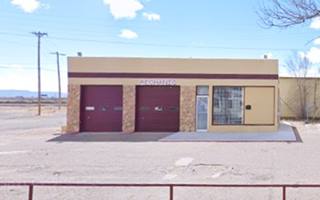 former Texaco Route 66 Grants NM box shaped gas station, flat roof, no canopy 2 service bays no pumps, seen from Route 66