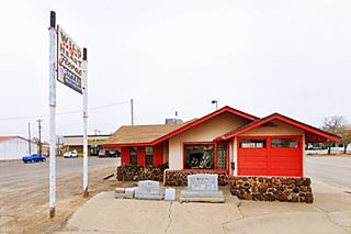 gable roof stone faced cottage style building